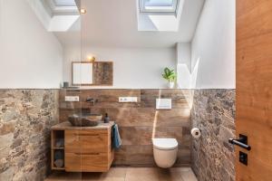 a bathroom with a sink and a toilet at Ferienwohnung Vrenal in Farchant +25 photos