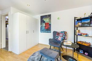 a living room with a chair and a table at My Cocoon in Lüdenscheid