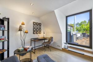a living room with a desk and a window at My Cocoon in Lüdenscheid
