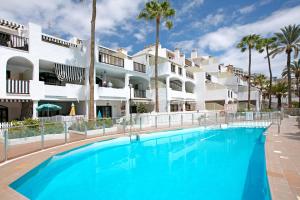 a large swimming pool in front of a building at Casa Princesa in Playa del Cura