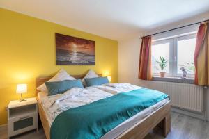 a bedroom with a large bed and a window at Niebüllhus in Niebüll