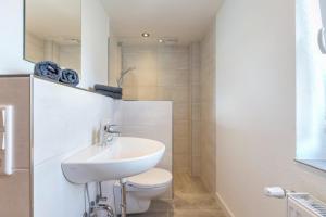 a white bathroom with a sink and a toilet at Niebüllhus in Niebüll +19 photos