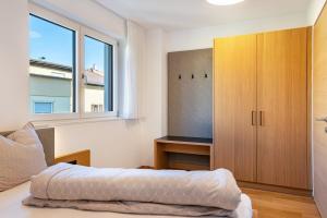 a bedroom with a bed and a large window at Ferienwohnungen Karin - Gala in Termeno