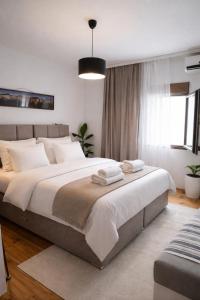a bedroom with a large bed with towels on it at Holiday home Haustor with Skadar lake view in Cetinje