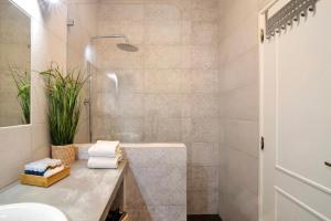 a bathroom with a sink and a shower at Âncora B in Monte Gordo +22 photos