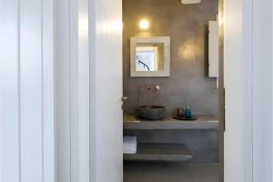 a bathroom with a sink and a mirror at Echinousa Kimolos Maisonette no4 in Kimolos