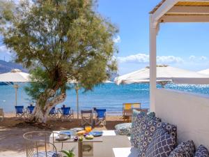 a patio with a table and a view of the ocean at Echinousa Kimolos Maisonette no4 in Kimolos +18 photos