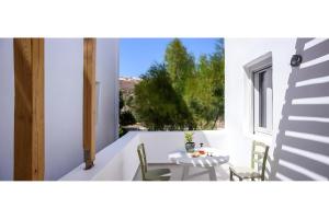 a room with a table and chairs and a window at Echinousa Kimolos Maisonette no4 in Kimolos