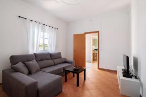 a living room with a couch and a television at Quinta Alegre Tavira T3 in Luz de Tavira