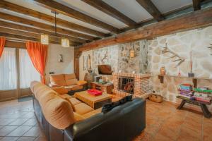 a living room with a couch and a fireplace at Casa Las Tres Coteras in Muñopedro