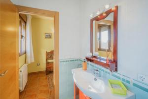 a bathroom with a sink and a mirror at Casa Las Tres Coteras in Muñopedro +17 photos