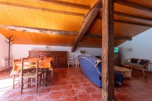 a dining room with a table and a blue couch at Maison Yaitua in Esterençuby +23 photos