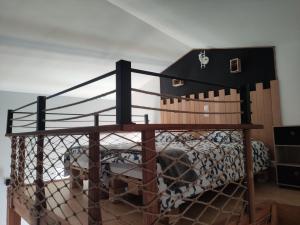 a dog in a cage next to a boat at Chez nono et vero in Roussillon en Isere