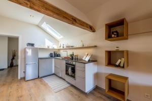 a kitchen with a refrigerator and a stove at Ferienwohnung Linde in Taching am See