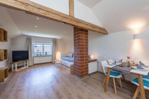 a living room with a table and a dining room at Ferienwohnung Linde in Taching am See