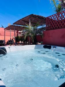 a jacuzzi tub with water in a yard at Riad Bamaga in Marrakesh