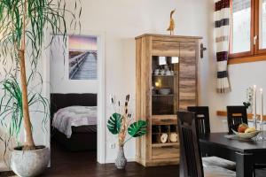 a dining room with a table and a wooden cabinet at Ferienhaus am Millibach in Wehingen