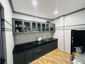 a kitchen with a black counter and a sink at Sam's homestay in Ấp Bình Hưng