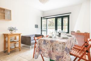 a dining room with a table and chairs at Appartamento Pini in Cala Gonone +16 photos