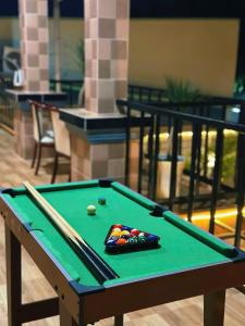 a green pool table with billiard balls on it at Sam's homestay in Ấp Bình Hưng