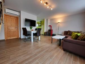 a living room with a couch and a table at Ferienhaus Emelie Geiseltalsee in Mücheln