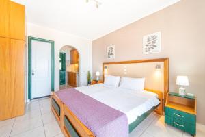 a bedroom with a large bed in a room at Spyridoula Studio 11 in Paleokastritsa