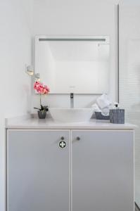 a bathroom with a white sink and a mirror at Sweet Home Madeira in Camacha +16 photos