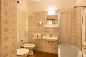 a bathroom with a toilet and a sink at Ferienwohnung 2 Vikoler in Vols am Schlern +28 photos