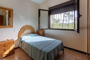 a bedroom with a bed and a window and a dresser at Las Pedrizas in Pilar de la Horadada +22 photos