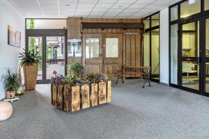 a lobby with a bench and some plants and windows at Fewo Luzia in Schönwald +28 photos