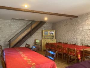 a dining room with a red table and chairs at Chez Bilhouet in Segonzac +40 photos