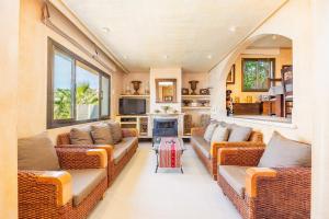 a living room with two couches and a fireplace at Villa Cala Llamp in Port d'Andratx
