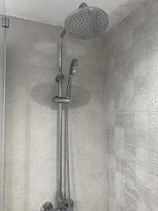 a shower with a shower head in a bathroom at Costa Brava beach studio in Sant Antoni de Calonge