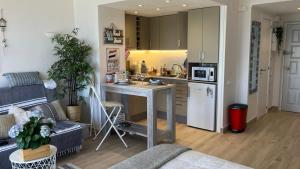 a kitchen and a living room with a table in a room at Costa Brava beach studio in Sant Antoni de Calonge
