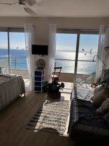 a bedroom with a bed and a view of the ocean at Costa Brava beach studio in Sant Antoni de Calonge
