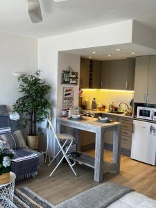 a kitchen with a table in the middle of a room at Costa Brava beach studio in Sant Antoni de Calonge +33 photos
