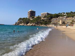 a group of people in the water at the beach at Costa Brava beach studio in Sant Antoni de Calonge