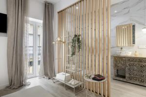 a living room with a wooden partition with a table at Barsanz Palace Home in Alcalá del Valle