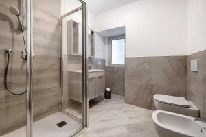 a bathroom with a shower and a toilet and a sink at Casa Vera Aurora Lake Garda in Torri del Benaco +10 photos