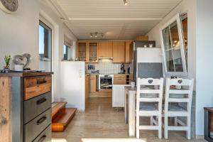 a kitchen with a refrigerator and a table and chairs at Chilli Home in Tettnang +25 photos