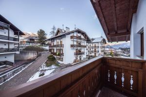an apartment balcony with a view of a building at La Pratolina Attico in Castello di Fiemme