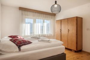 a bedroom with a large bed and a window at Ciasa De Marugiana in Gardeccia - San Giovanni di Fassa