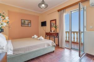 a bedroom with a bed and a balcony at Villa sea view 1 in Athani +23 photos