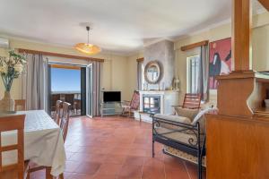a living room with a table and a fireplace at Villa sea view 1 in Athani