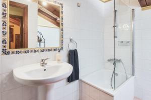 a bathroom with a sink and a shower at El Serenal in Santa Maria de Valdeón +36 photos