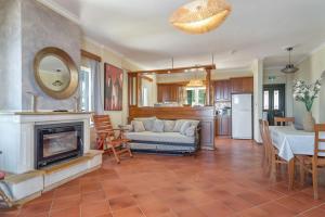 a living room with a couch and a fireplace at Villa sea view 1 in Athani