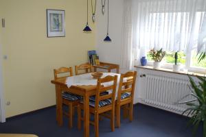 a dining room with a table and chairs and a window at Haus Elke in Gomadingen