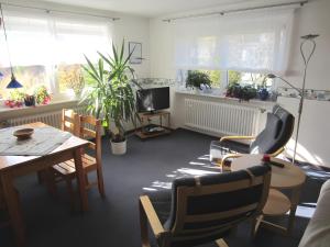 a living room with a table and chairs and a television at Haus Elke in Gomadingen