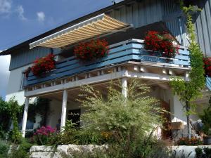 a house with flower boxes on the balcony at Haus Elke in Gomadingen