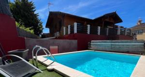 a swimming pool in the backyard of a house at Villa Tanqueta in Santa Brígida